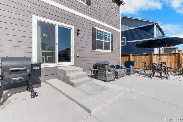 a view of a patio with couches under an umbrella