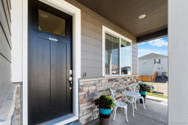 a view of a balcony with table and chairs and a potted plant