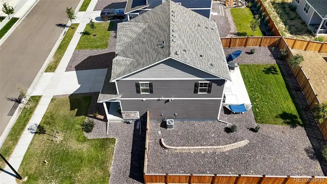 an aerial view of a house with swimming pool and wooden stairs