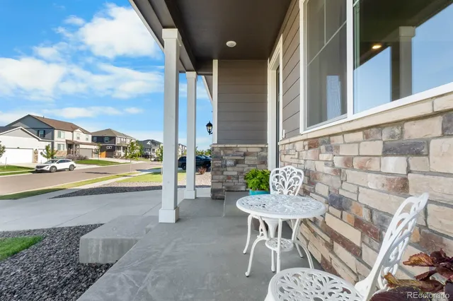 a view of a workspace with furniture and window