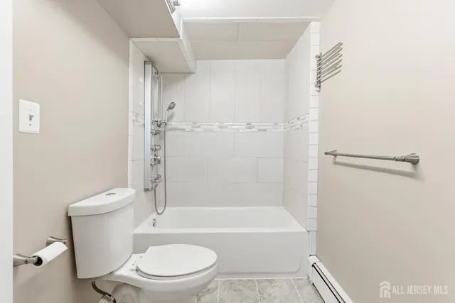 a bathroom with a toilet and a bath tub