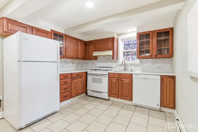 a kitchen with a refrigerator sink and cabinets