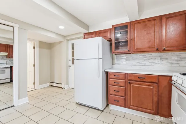 a view of kitchen with stainless steel appliances granite countertop a refrigerator and a sink