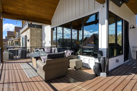 a view of a balcony with floor to ceiling windows with wooden floor