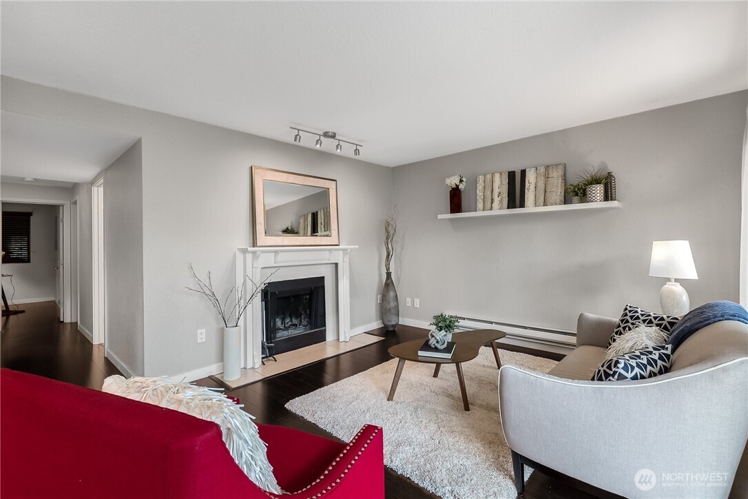 1311 12th Avenue South, Unit D202 Seattle, WA 98144 - Photo 5 of 20 a living room with furniture and a fireplace