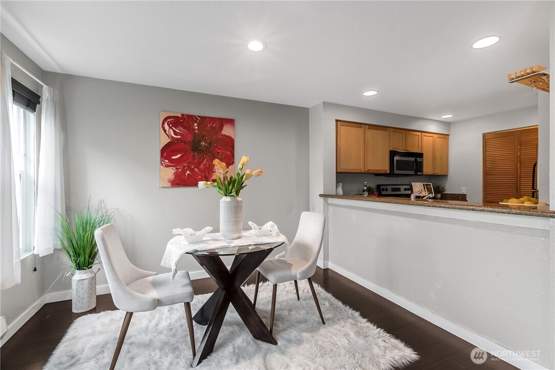 1311 12th Avenue South, Unit D202 Seattle, WA 98144 - Photo 6 of 20 a view of a dining room with furniture and a kitchen