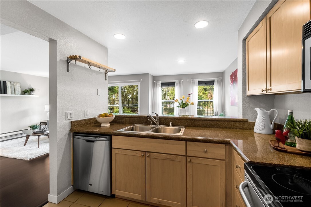 1311 12th Avenue South, Unit D202 Seattle, WA 98144 - Photo 9 of 20 a kitchen with a sink and cabinets