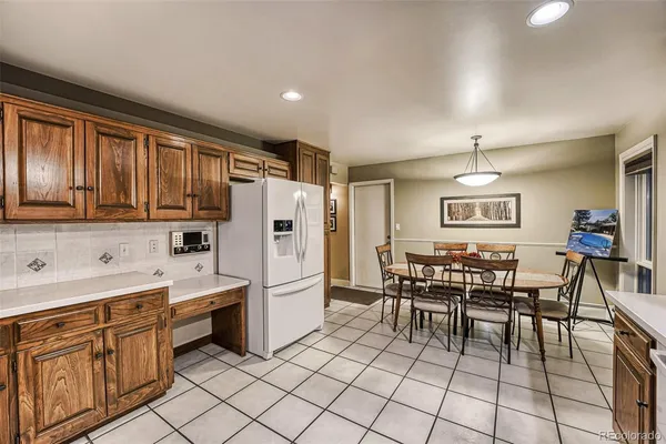 a kitchen with stainless steel appliances granite countertop a refrigerator sink and stove