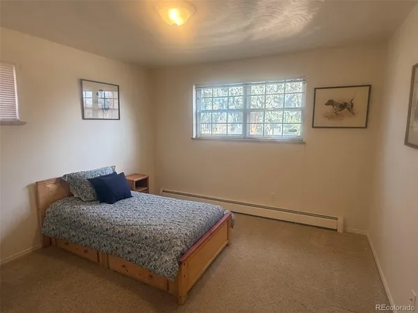 a bedroom with two beds and painting on the wall