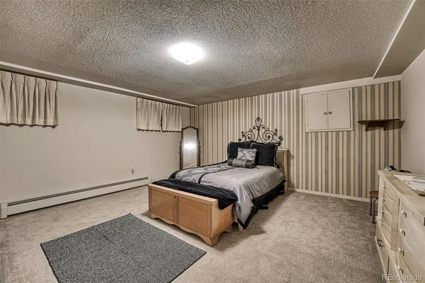 a bedroom with a bed and a view of room