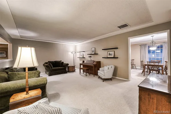 a living room with furniture and a lamp