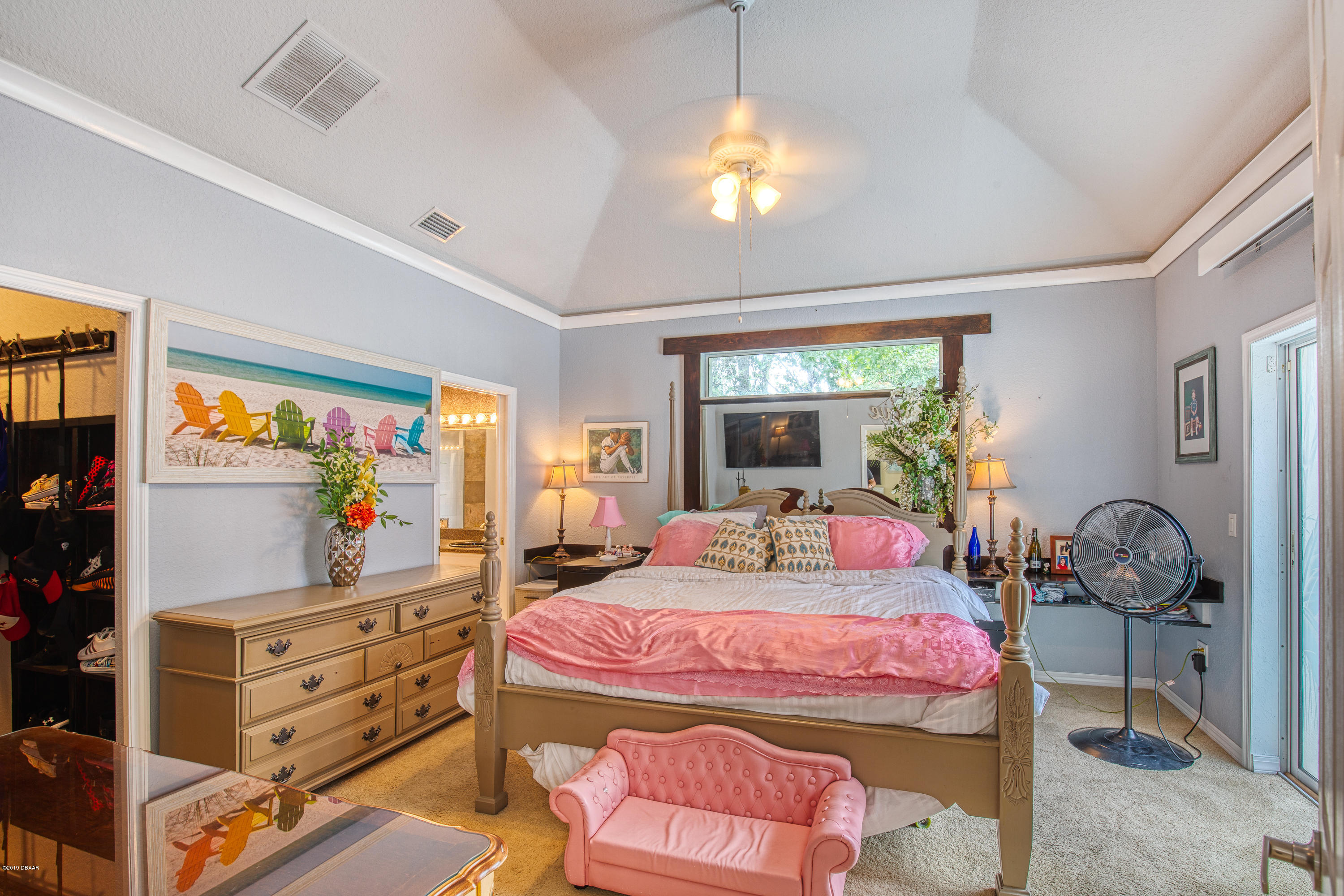 36 Pine Tree Drive Palm Coast, FL 32164 - Photo 14 of 52 a bedroom with a bed and large windows