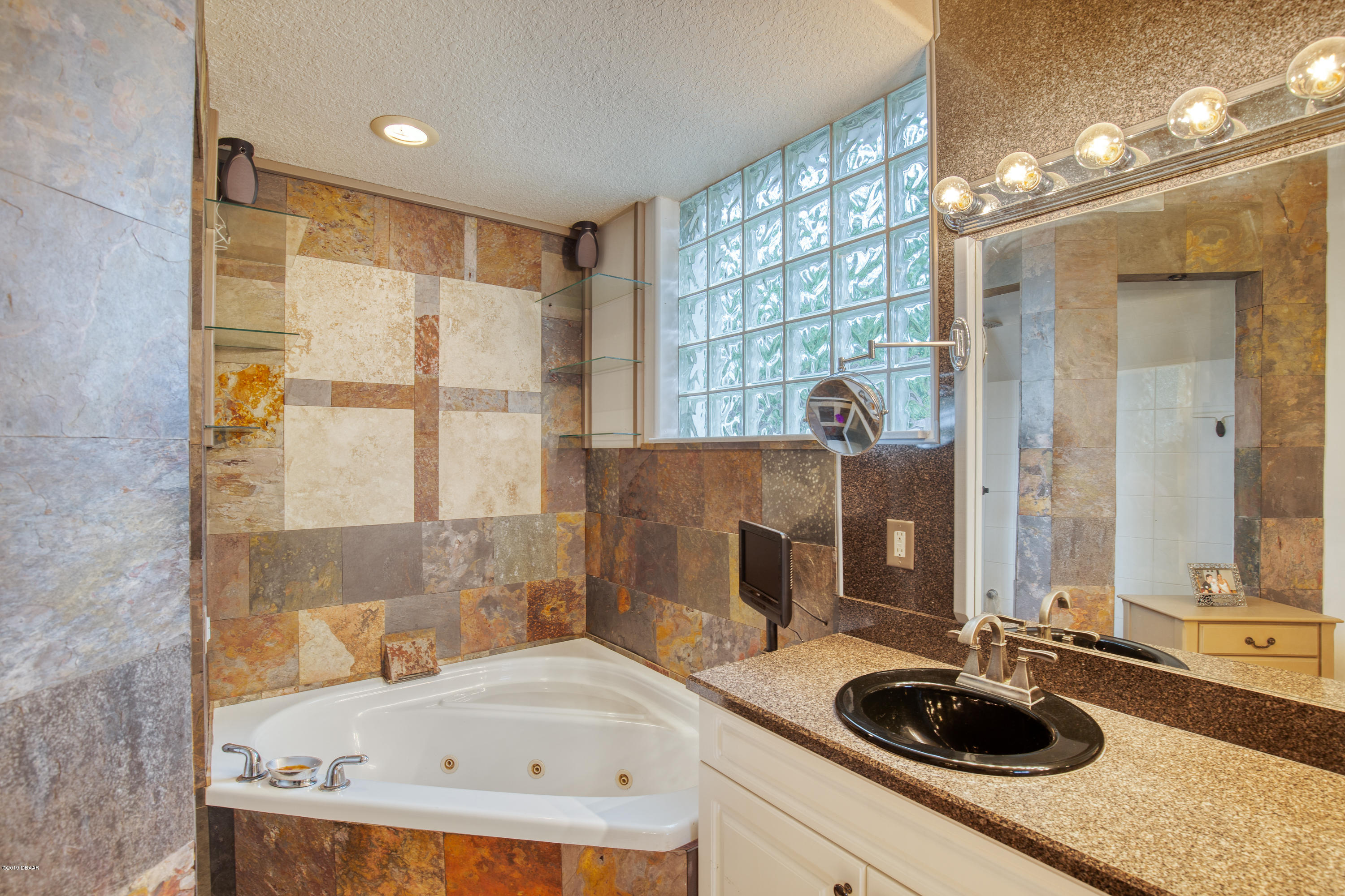 36 Pine Tree Drive Palm Coast, FL 32164 - Photo 19 of 52 a bathroom with a sink and a tub