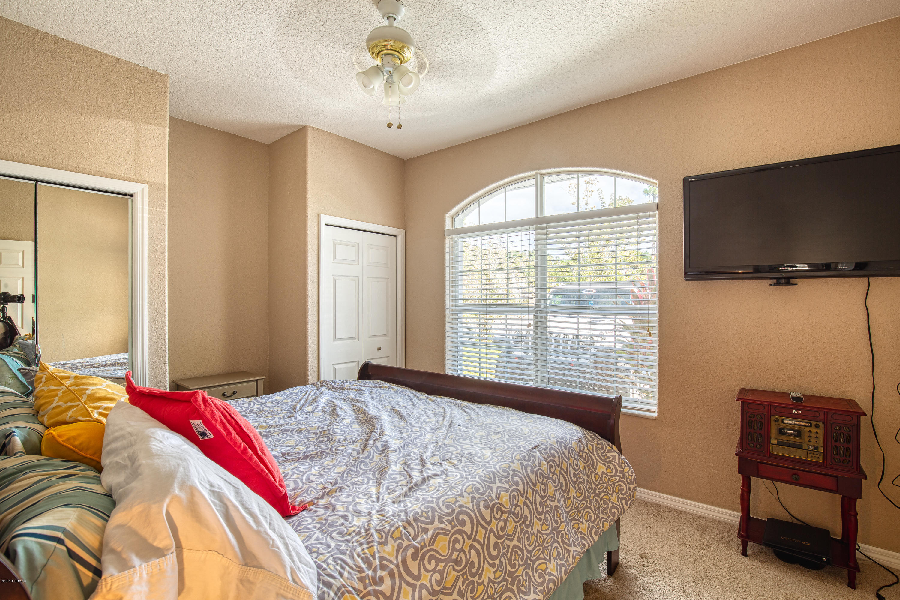 36 Pine Tree Drive Palm Coast, FL 32164 - Photo 23 of 52 a bedroom with a bed and a television