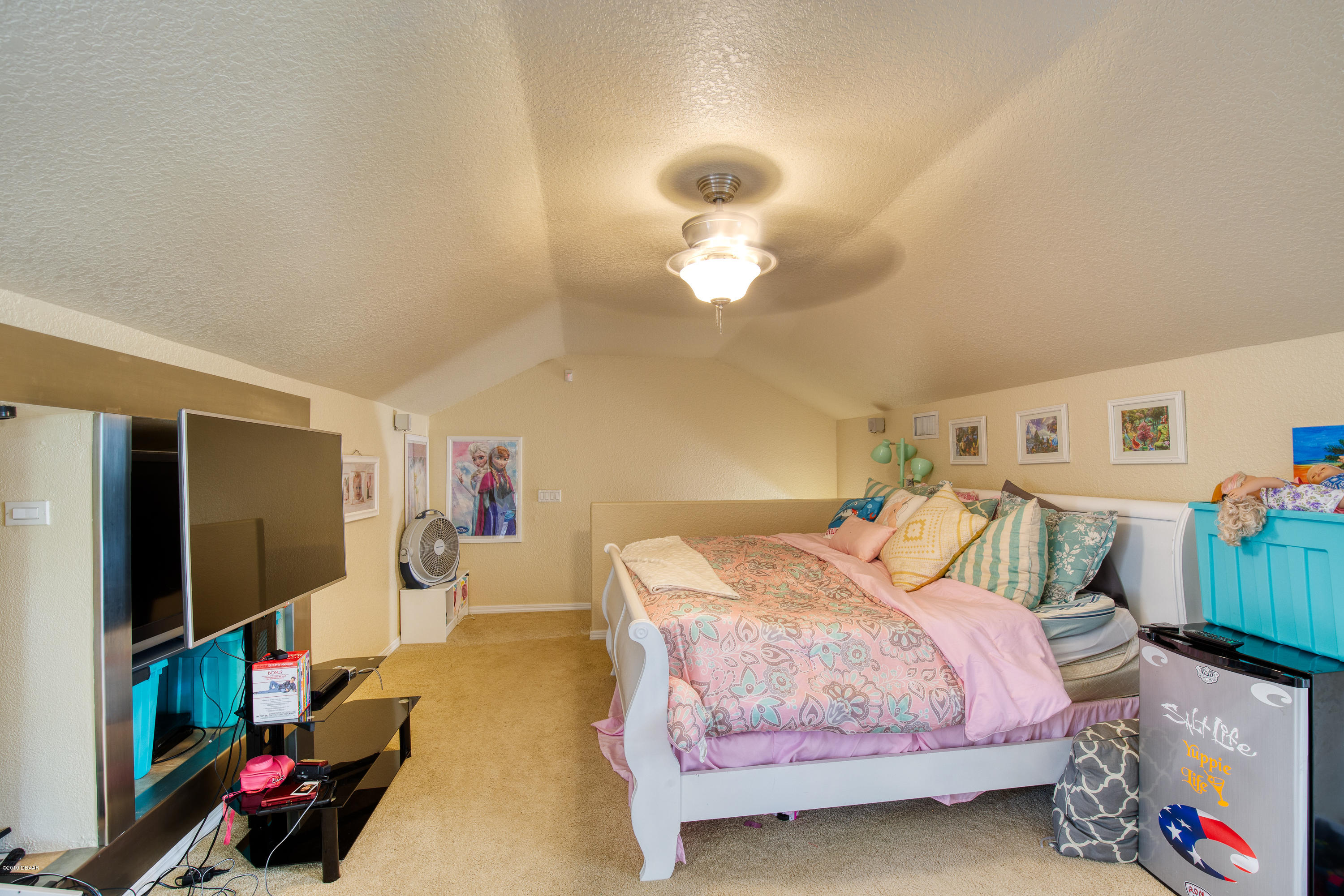 36 Pine Tree Drive Palm Coast, FL 32164 - Photo 29 of 52 a bedroom with bed and a flat tv screen on dresser