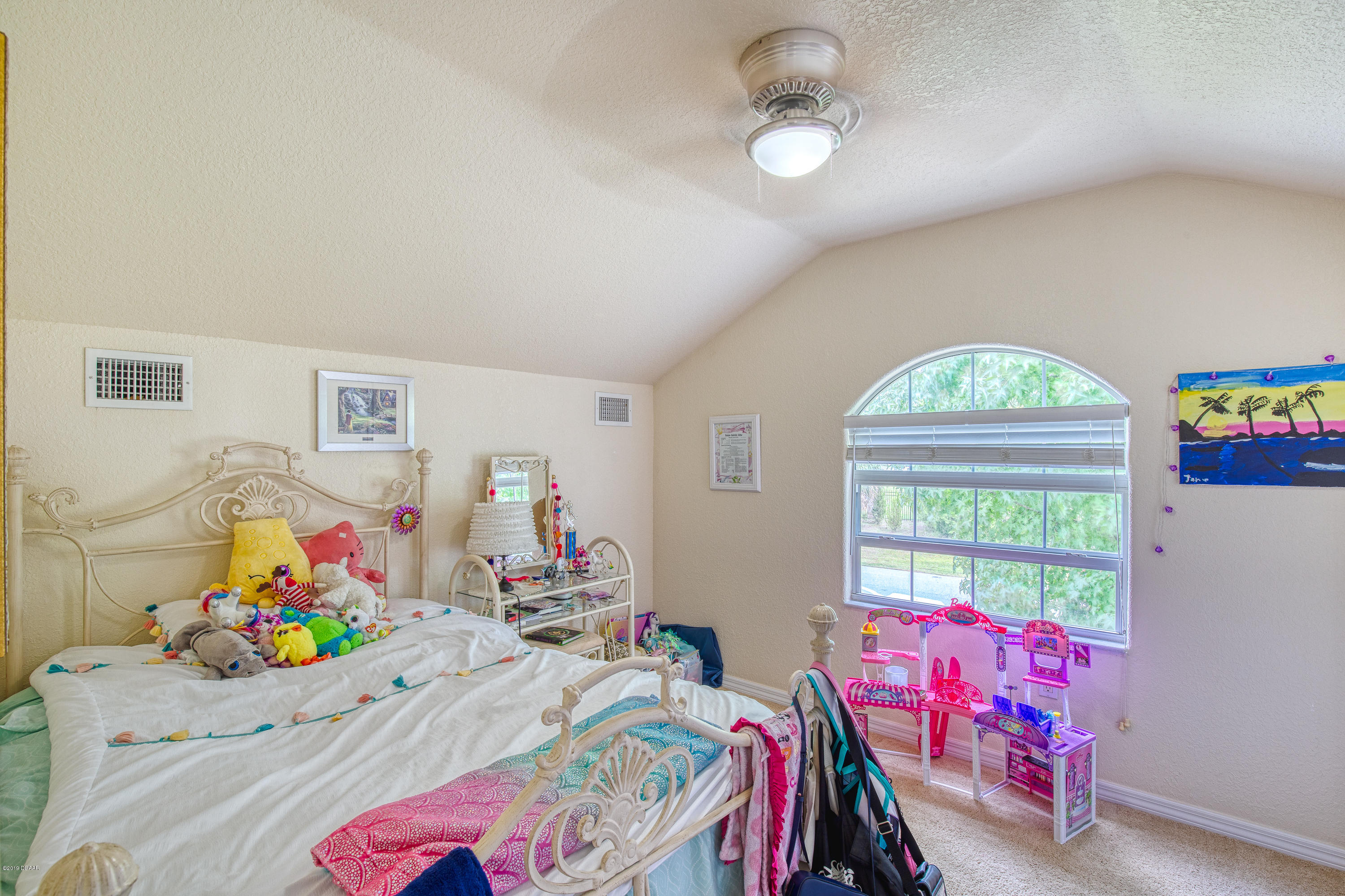 36 Pine Tree Drive Palm Coast, FL 32164 - Photo 30 of 52 a bedroom with a bed and a window