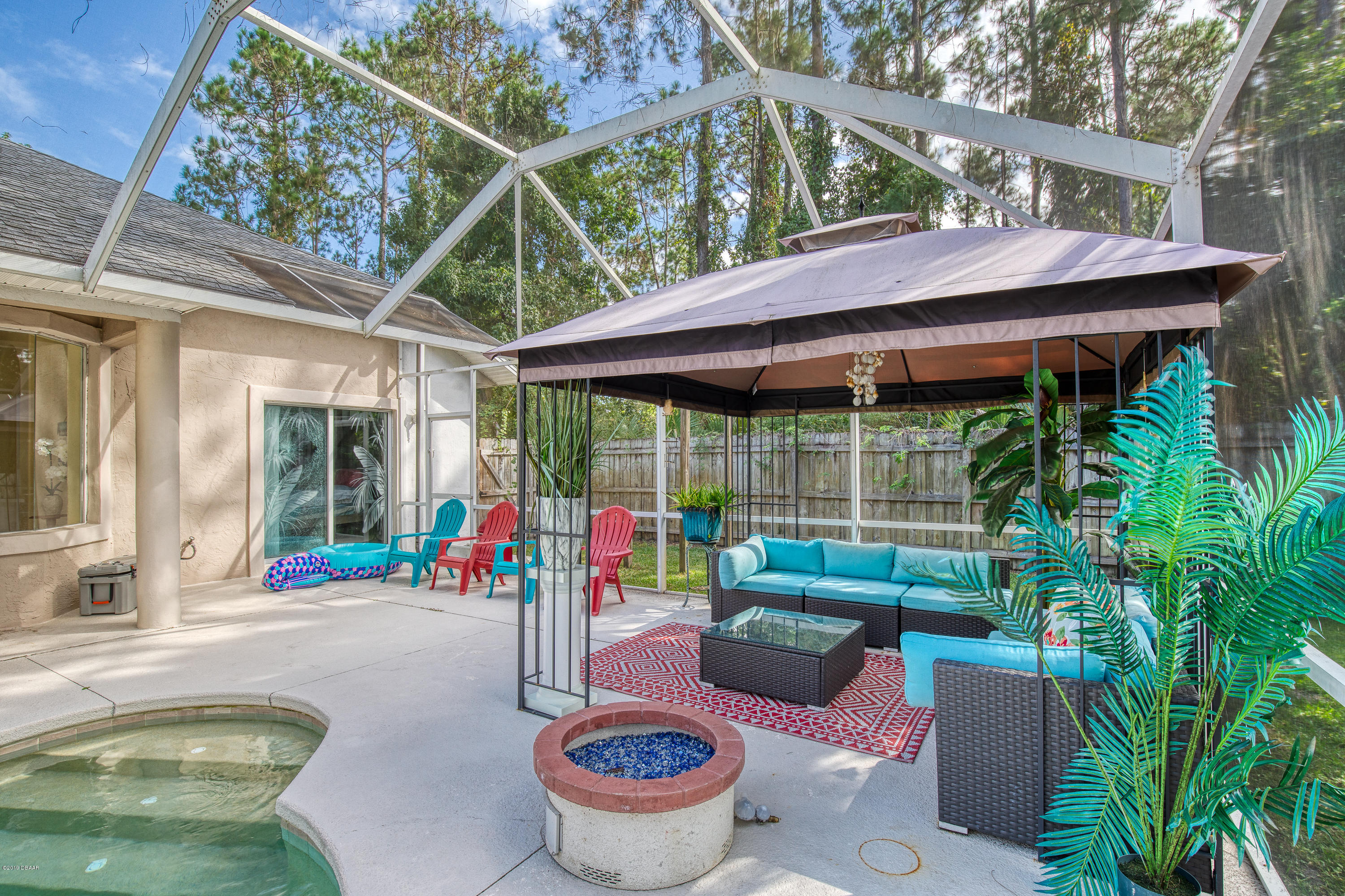 36 Pine Tree Drive Palm Coast, FL 32164 - Photo 34 of 52 a backyard of a house with outdoor seating