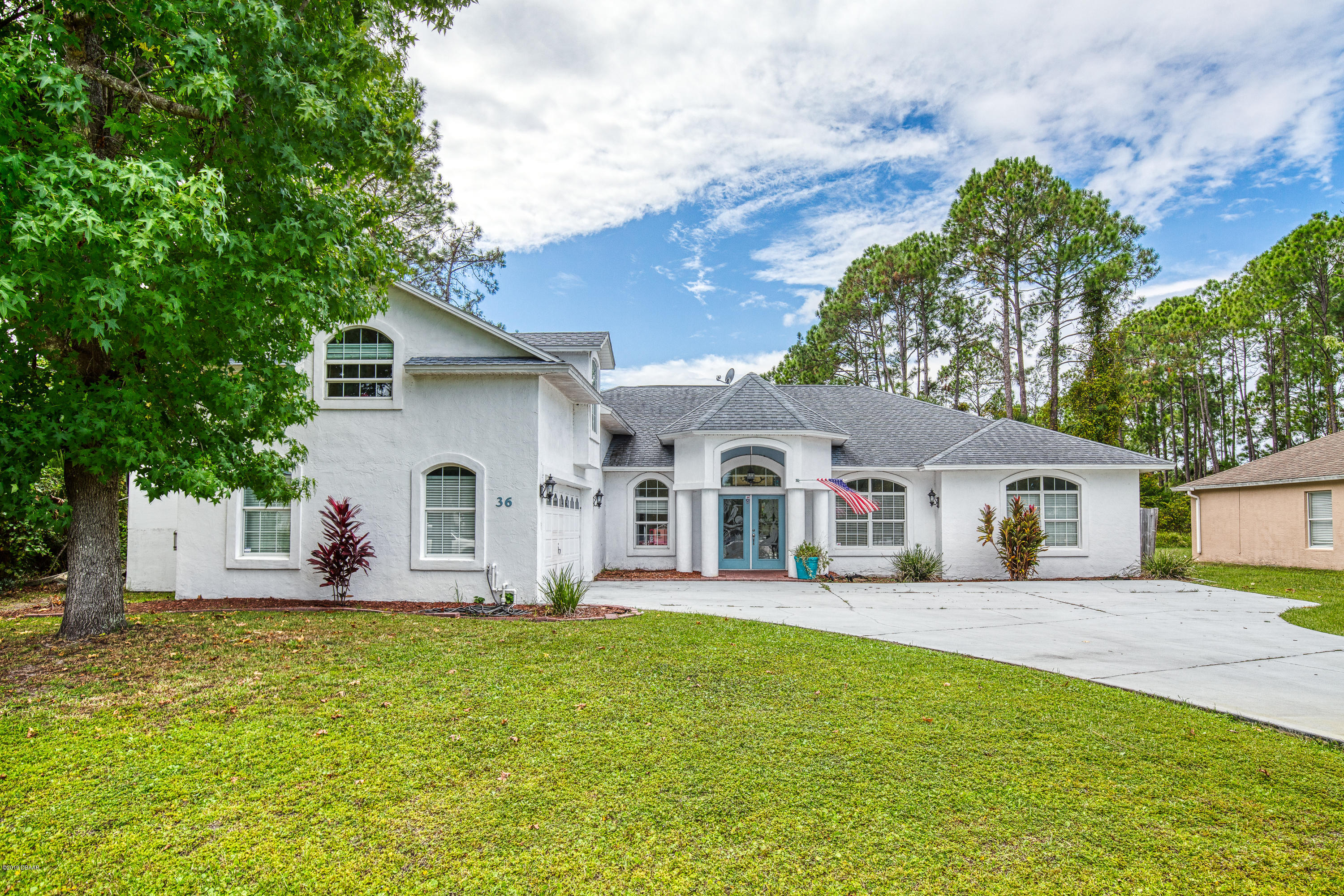 36 Pine Tree Drive Palm Coast, FL 32164 - Photo 52 of 52 a front view of house with yard and green space