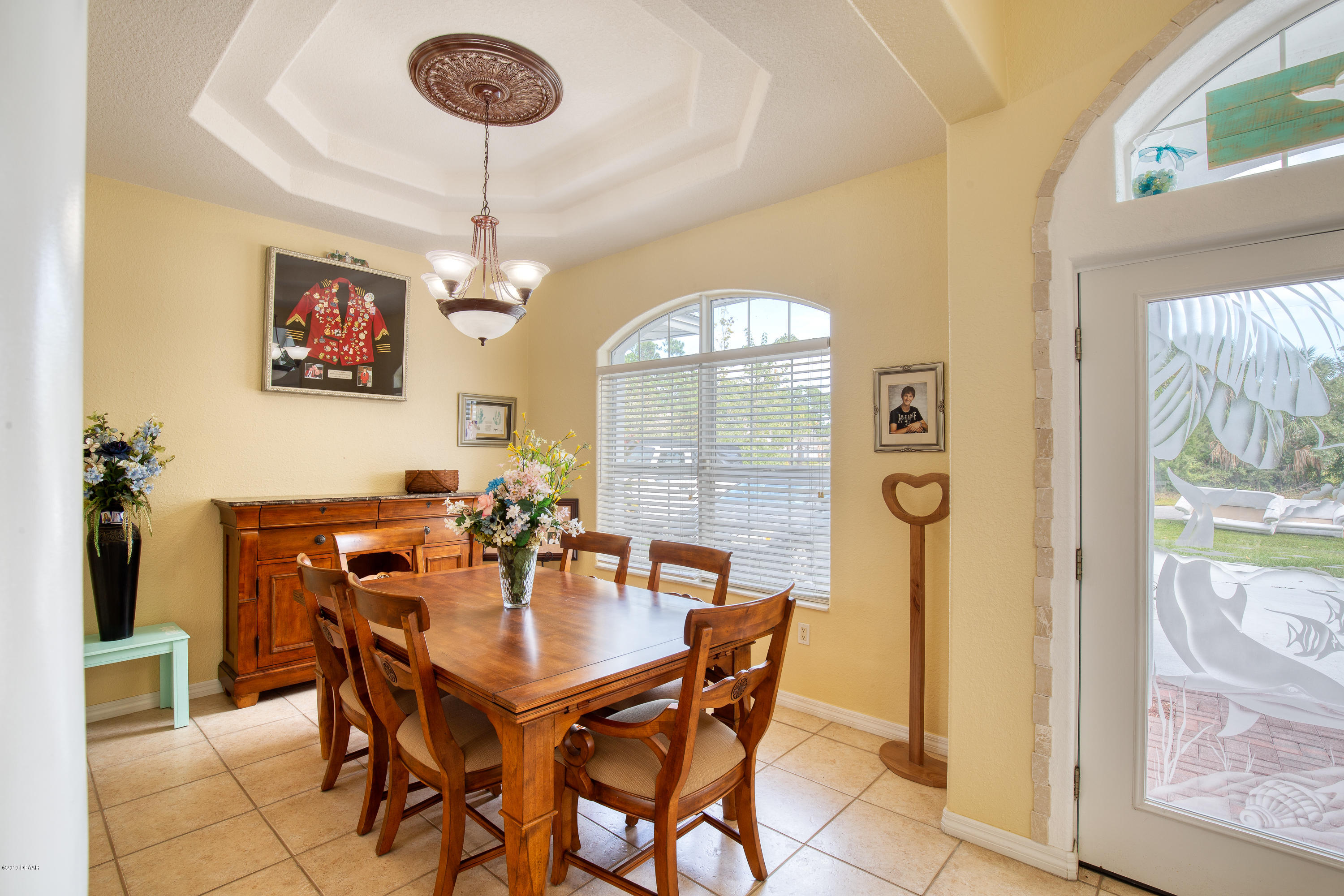 36 Pine Tree Drive Palm Coast, FL 32164 - Photo 7 of 52 a view of a dining room with furniture and a chandelier