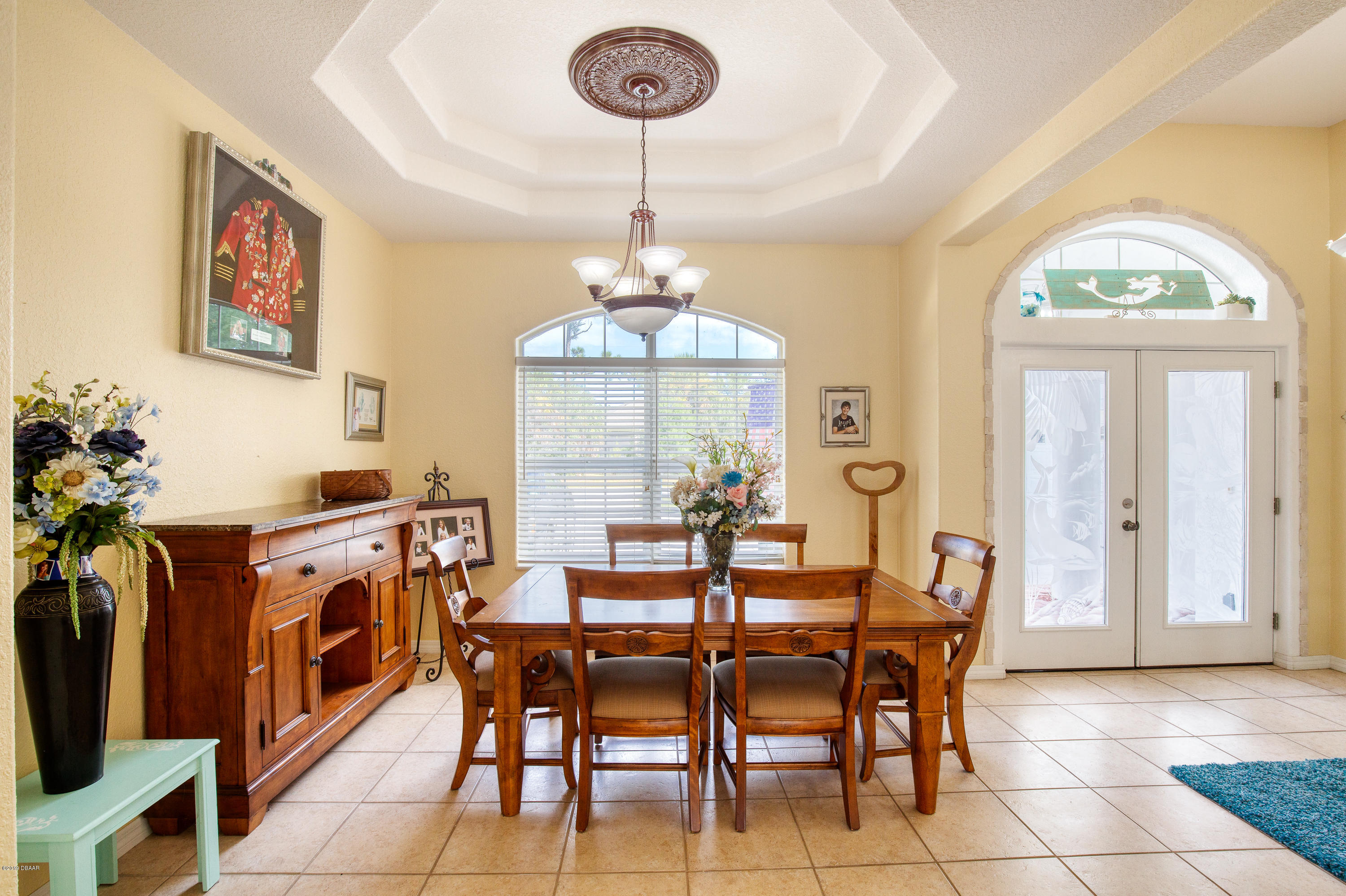 36 Pine Tree Drive Palm Coast, FL 32164 - Photo 9 of 52 a view of a dining room with furniture and a chandelier