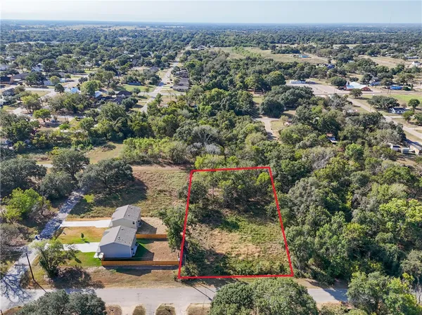 an aerial view of a houses with a yard