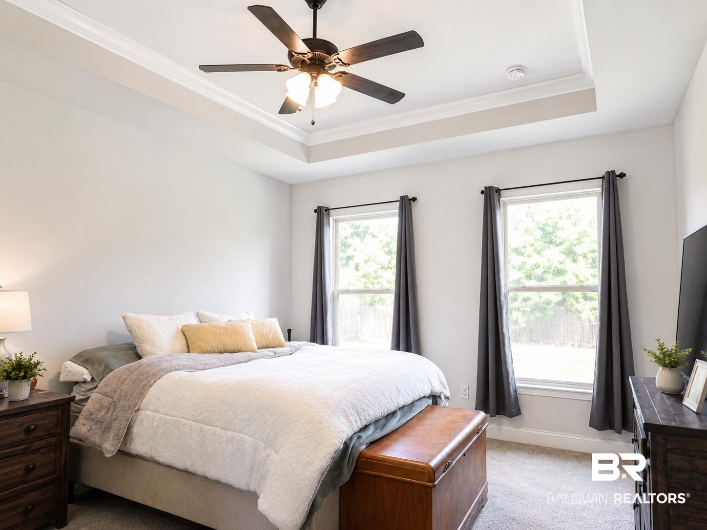 1097 Stella Road Foley, AL 36535 - Photo 9 of 15 Bedroom featuring two windows, recessed tray ceiling with crown molding, and a ceiling fan