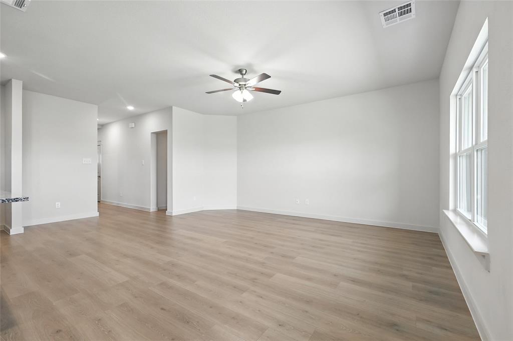 1795 Gleasondale Place Forney, TX 75126 - Photo 9 of 29 Empty room with ceiling fan, light wood finished floors, and recessed lighting