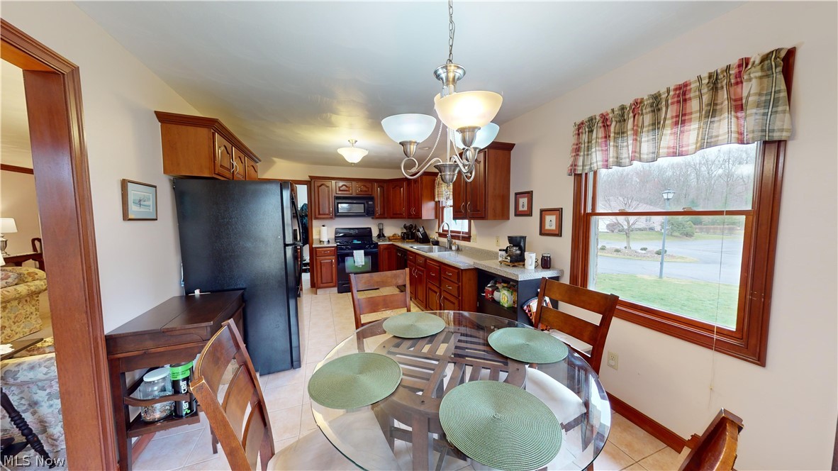 167 Mathews Road, Unit B Youngstown, OH 44512 - Photo 16 of 34 Tiled dining room featuring a chandelier and sink