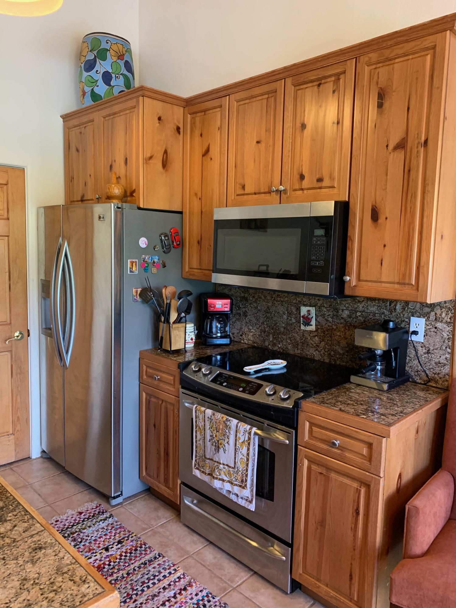 323 Adams Ranch Road, Unit 5B Mountain Village, CO 81435 - Photo 11 of 30 a kitchen with stainless steel appliances granite countertop a stove a refrigerator and a microwave