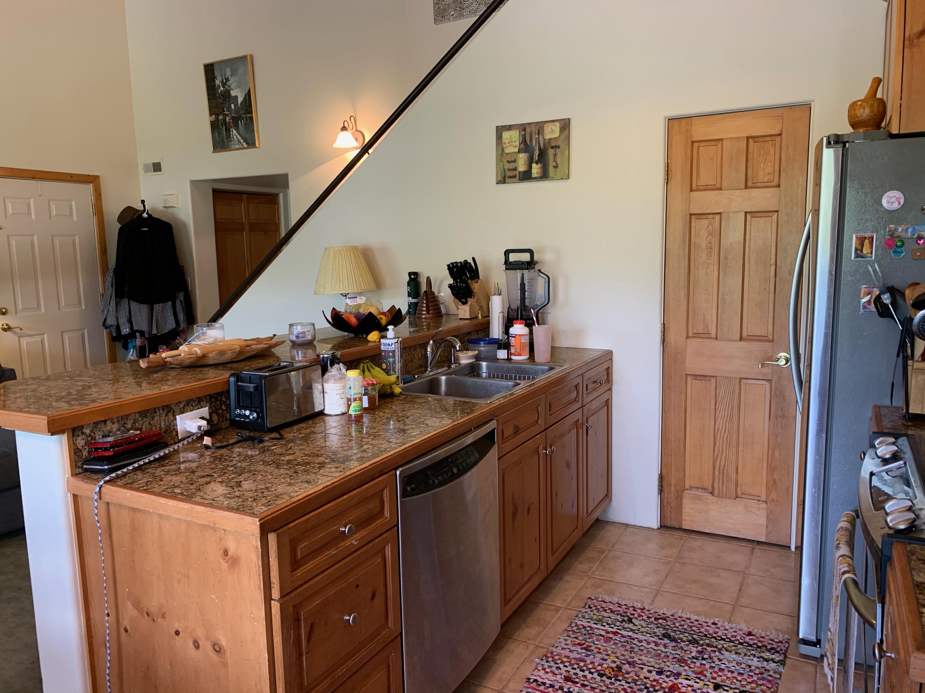 323 Adams Ranch Road, Unit 5B Mountain Village, CO 81435 - Photo 12 of 30 a kitchen with stainless steel appliances granite countertop a sink a stove and a refrigerator