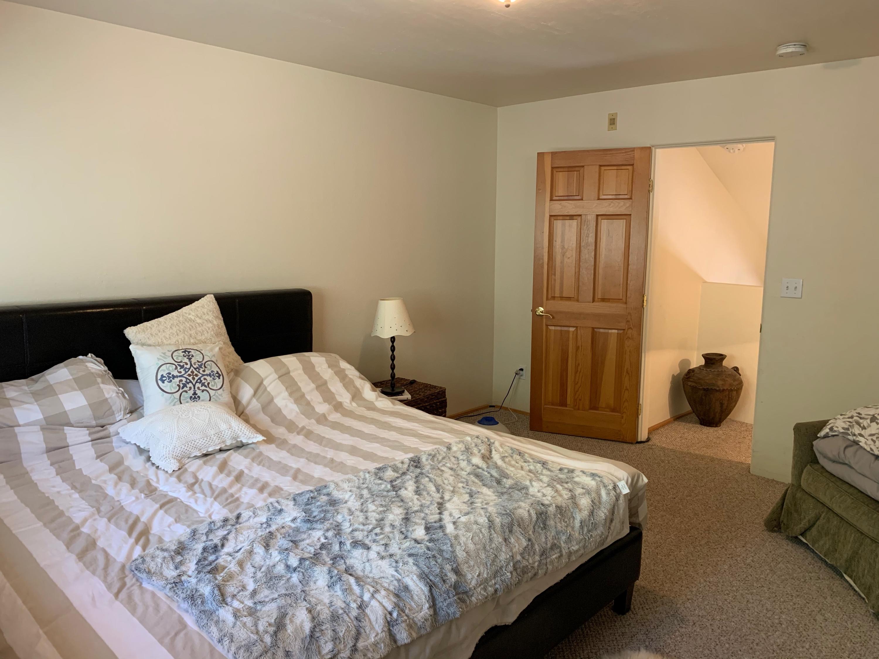 323 Adams Ranch Road, Unit 5B Mountain Village, CO 81435 - Photo 13 of 30 a bedroom with a bed and couch