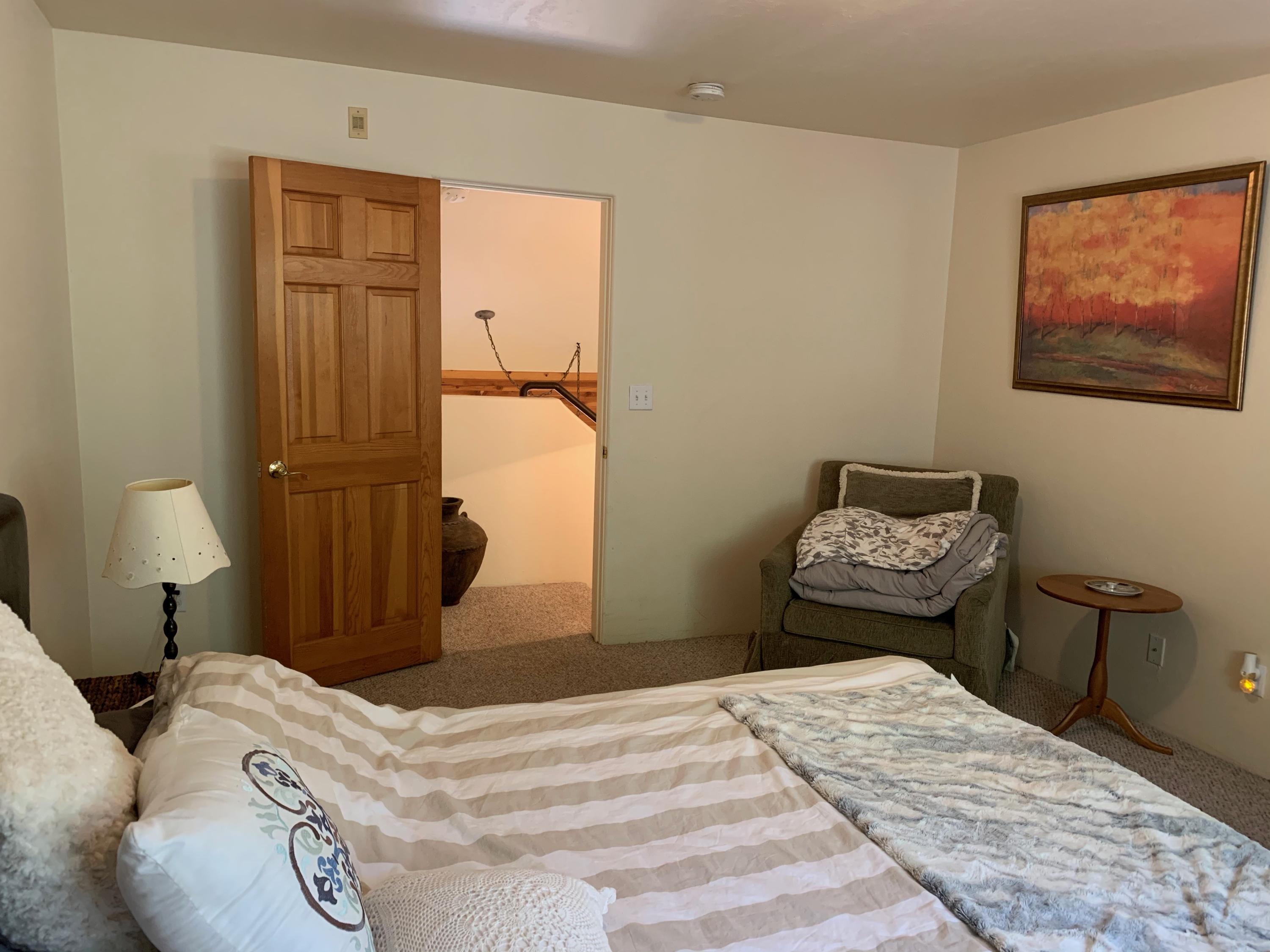 323 Adams Ranch Road, Unit 5B Mountain Village, CO 81435 - Photo 15 of 30 a bedroom with a bed and wooden floor