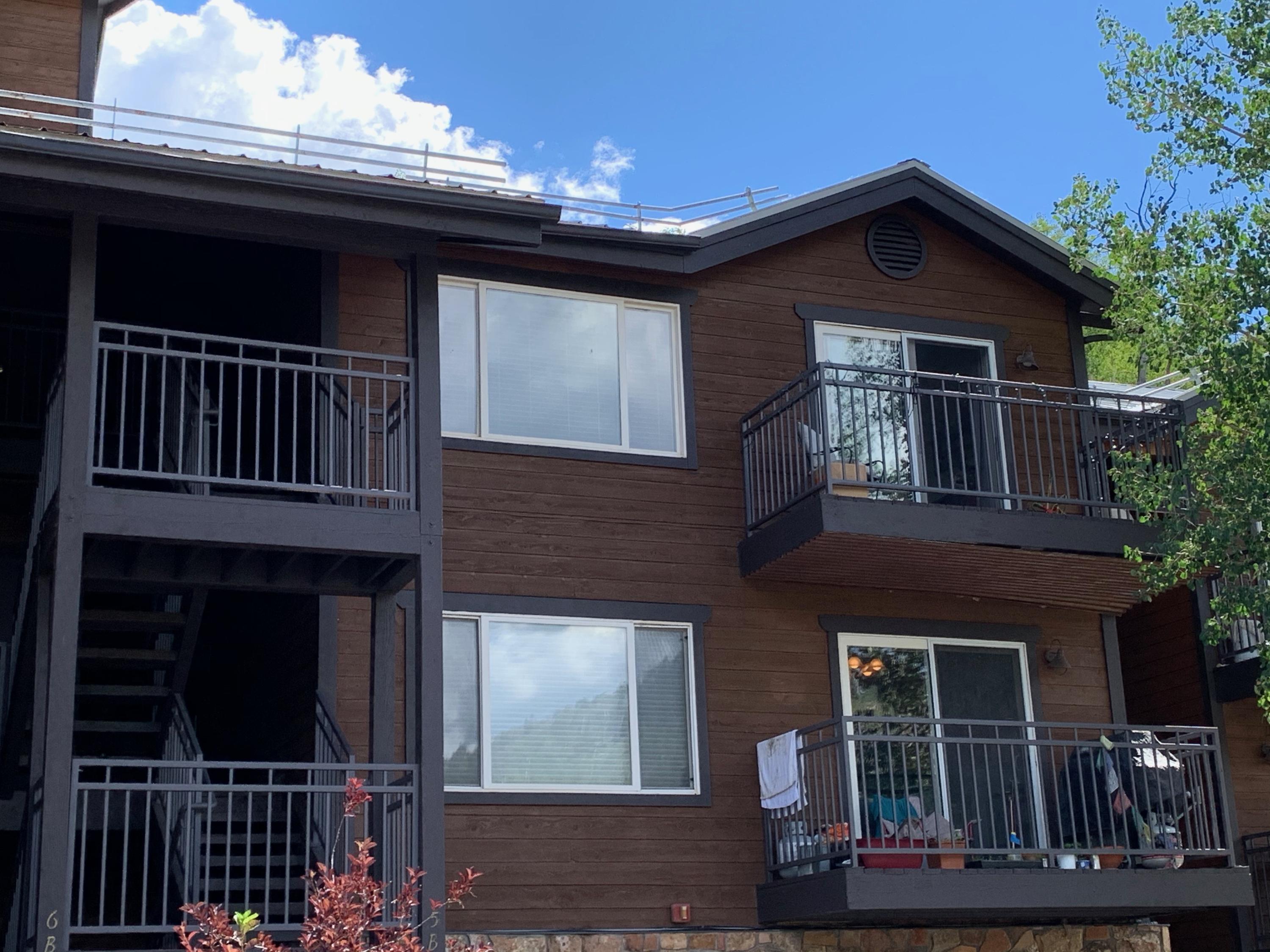 323 Adams Ranch Road, Unit 5B Mountain Village, CO 81435 - Photo 2 of 30 a front view of a house with a balcony