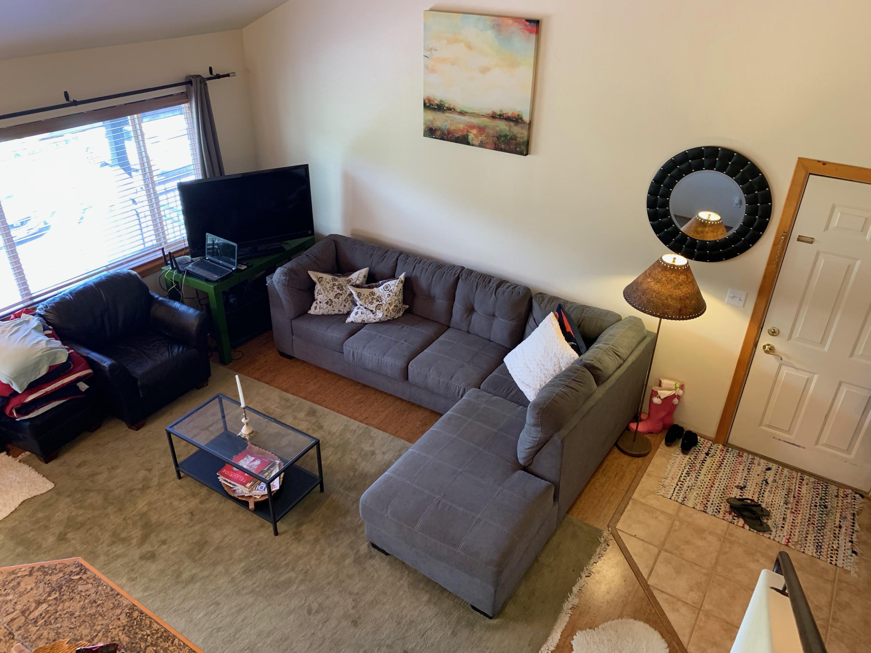 323 Adams Ranch Road, Unit 5B Mountain Village, CO 81435 - Photo 5 of 30 a living room with furniture and a floor to ceiling window