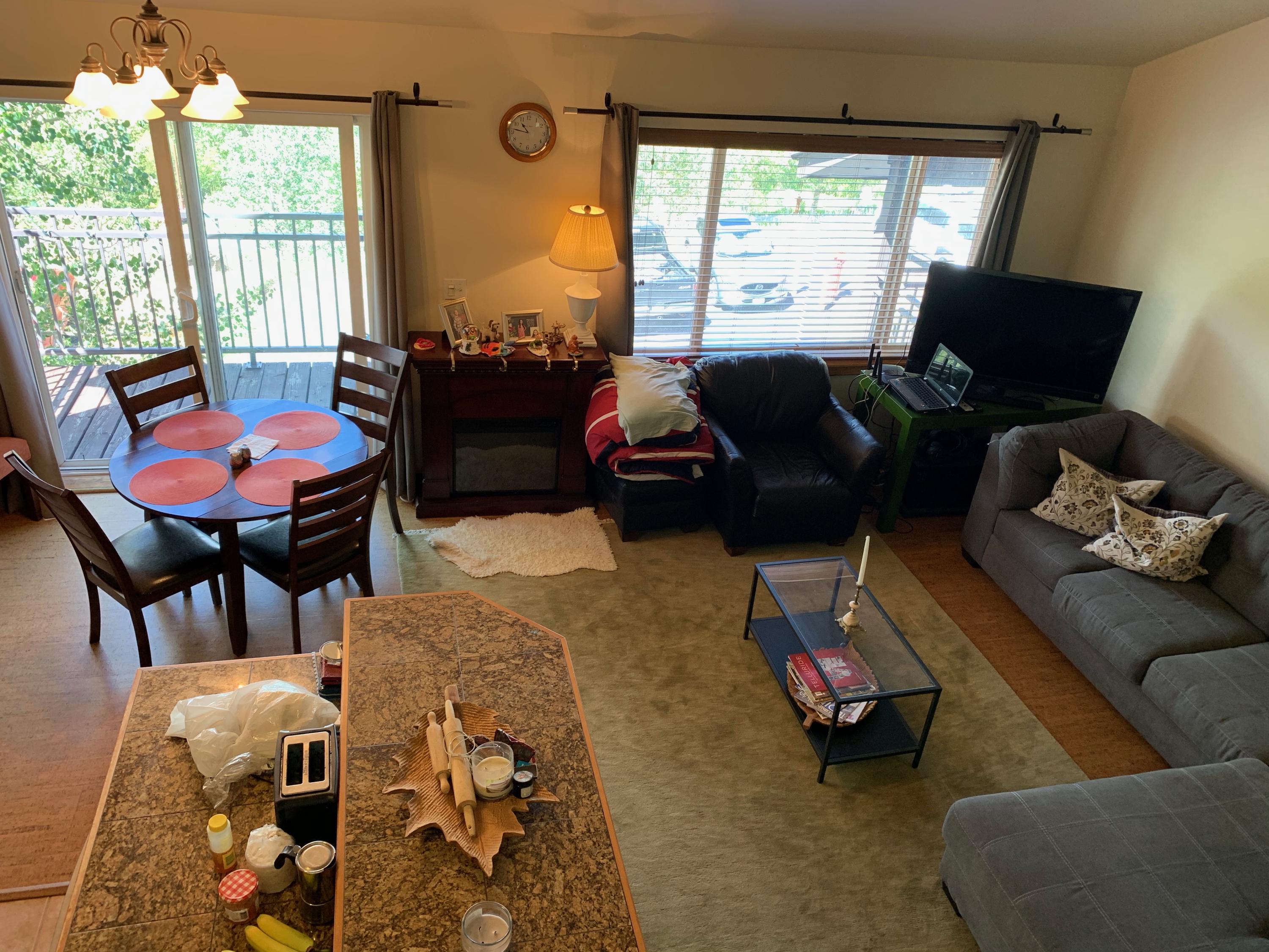 323 Adams Ranch Road, Unit 5B Mountain Village, CO 81435 - Photo 6 of 30 a living room with furniture and a large window