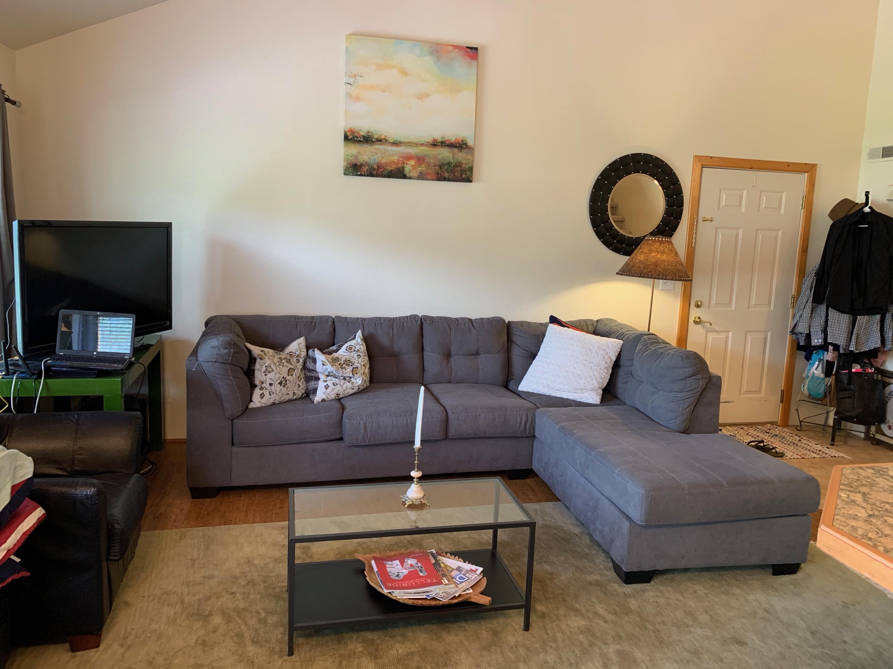 323 Adams Ranch Road, Unit 5B Mountain Village, CO 81435 - Photo 7 of 30 a living room with furniture and a flat screen tv