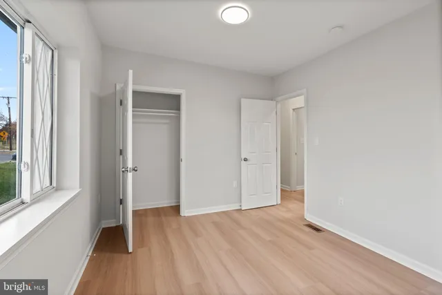a view of a room with wooden floor and windows