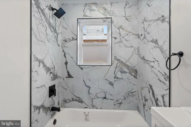 a bathroom with a bathtub and shower