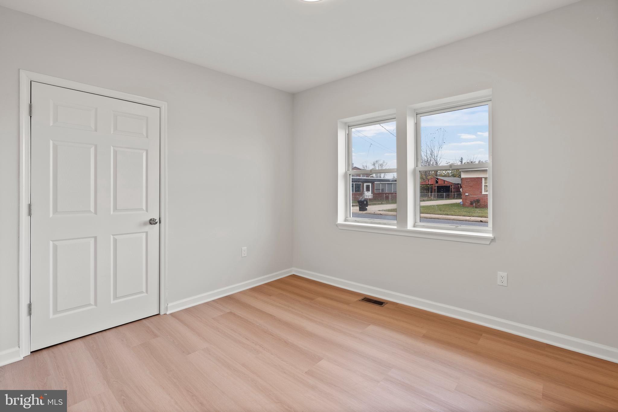 730 New Pittsburg Avenue, Unit 1 Baltimore, MD 21222 - Photo 18 of 27 a view of empty room with wooden floor and fan