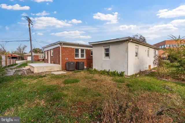a white house that has a small yard and a large window