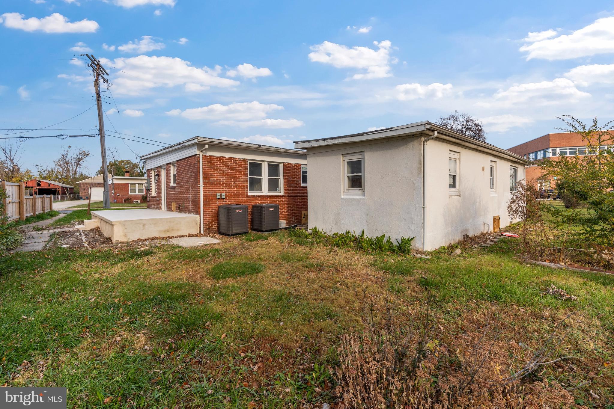 730 New Pittsburg Avenue, Unit 1 Baltimore, MD 21222 - Photo 24 of 27 a white house that has a small yard and a large window
