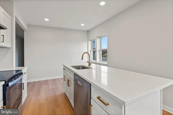 a hallway with sink and mirror
