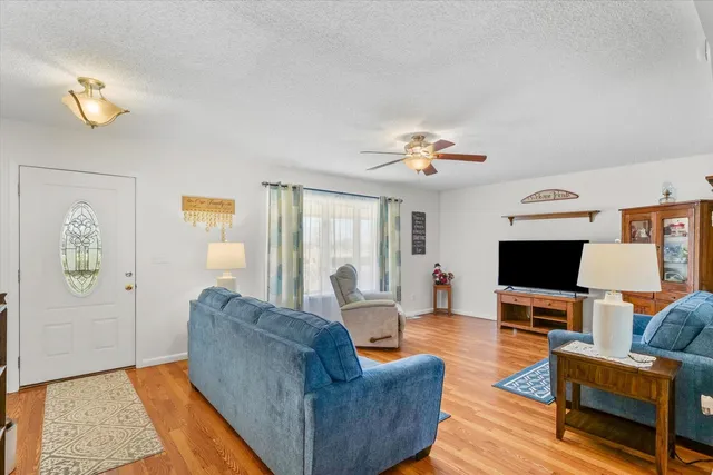 a living room with furniture and a chandelier
