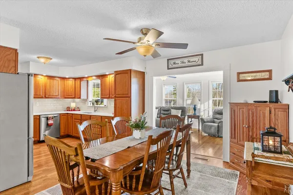 a large kitchen with stainless steel appliances granite countertop a sink and cabinets