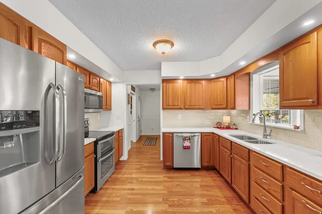 a kitchen with stainless steel appliances a refrigerator stove and microwave