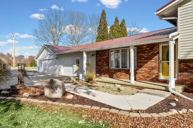a view of a house with backyard porch and sitting area