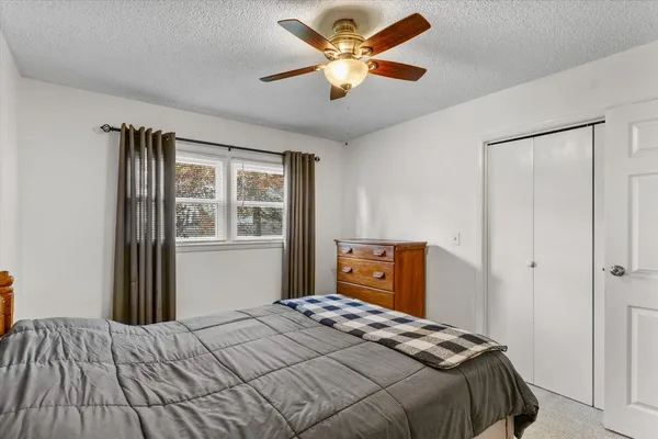 a bedroom with a bed and a dresser