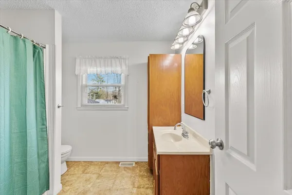 a room with a bed and cabinets