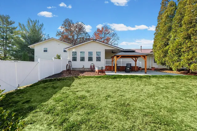 a view of a patio with a table and chairs under an umbrella