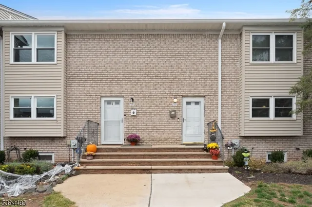 a front view of a house with many windows